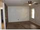 This living room with textured walls, a ceiling fan, and a bright window at 8469 Shiloh Ct, Jonesboro, GA 30238