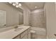 Bathroom featuring a vanity with mirror, toilet, and shower-tub combo with tiled walls at 1045 Penny Ln, Roswell, GA 30076