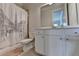 Bathroom with a white vanity, toilet, and shower featuring an Eiffel Tower curtain at 1045 Penny Ln, Roswell, GA 30076
