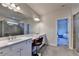 Bathroom showcasing double sinks, vanity with makeup area, and modern lighting above a large mirror at 1045 Penny Ln, Roswell, GA 30076