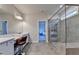 Modern bathroom featuring double sinks, frameless shower with bench, and vanity area with makeup lighting at 1045 Penny Ln, Roswell, GA 30076