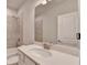 Bright bathroom featuring a modern vanity with white countertop, neutral tile, and shower-tub combo at 1045 Penny Ln, Roswell, GA 30076