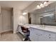 Bright bathroom boasting double sinks, vanity with makeup space, and a large mirror with modern lighting at 1045 Penny Ln, Roswell, GA 30076