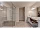 Modern bathroom featuring a frameless glass shower, gray tile, and a vanity with stylish lighting at 1045 Penny Ln, Roswell, GA 30076