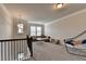 Large bonus room with ample natural light, carpeting, and a cozy seating area with overhead lighting at 1045 Penny Ln, Roswell, GA 30076