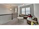 Inviting bonus room with plush carpeting, ample seating, and bright natural light from large windows at 1045 Penny Ln, Roswell, GA 30076