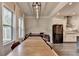 Bright dining area with a large table near windows and an open view to a kitchen at 1045 Penny Ln, Roswell, GA 30076
