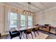Bright dining room features a modern light fixture and large windows at 1045 Penny Ln, Roswell, GA 30076