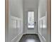 Bright entryway with paneled walls and a wood floor, creating a welcoming first impression at 1045 Penny Ln, Roswell, GA 30076
