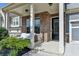 Inviting front porch featuring brick accents and a cozy outdoor seating area, perfect for relaxing at 1045 Penny Ln, Roswell, GA 30076