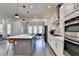 Open concept kitchen features a large island, stainless appliances, and dining area with large windows at 1045 Penny Ln, Roswell, GA 30076