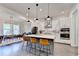 Bright kitchen features a large island with bar seating, a dining area, and stainless appliances at 1045 Penny Ln, Roswell, GA 30076