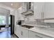 Bright kitchen features stainless appliances, white cabinets, subway tile backsplash and modern countertops at 1045 Penny Ln, Roswell, GA 30076
