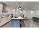 Open-concept kitchen with an island, stainless appliances, and a seamless flow into the living area at 1045 Penny Ln, Roswell, GA 30076