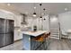 Contemporary kitchen showcases a large island with seating, stainless steel appliances, and modern finishes at 1045 Penny Ln, Roswell, GA 30076