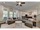 Open-concept living room featuring a large sectional sofa, modern decor, and a view into the kitchen at 1045 Penny Ln, Roswell, GA 30076