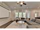 Cozy living room with a large sectional sofa, plush rug, and a projector screen for movie nights at 1045 Penny Ln, Roswell, GA 30076