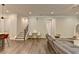Inviting living area with stairs, neutral color palette, and hardwood flooring offers a warm ambiance at 1045 Penny Ln, Roswell, GA 30076