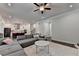 Open-concept living room boasts a sectional sofa, modern lighting, and seamless flow to the kitchen at 1045 Penny Ln, Roswell, GA 30076