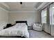 A cozy main bedroom with tray ceilings, neutral carpet, and large bright windows at 1045 Penny Ln, Roswell, GA 30076