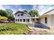 Expansive backyard showcasing a sunroom addition, patio, manicured landscaping, and mature trees at 2737 Fontainebleau Drive, Dunwoody, GA 30360