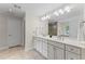 Bathroom with double sinks, white cabinets, and tile floors at 2737 Fontainebleau Drive, Dunwoody, GA 30360