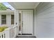 Classic white front door with sidelight and covered porch at 2737 Fontainebleau Drive, Dunwoody, GA 30360