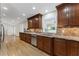 Stylish kitchen with stainless steel appliances, wood cabinets, and a view to the living area at 2737 Fontainebleau Drive, Dunwoody, GA 30360
