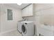 Laundry room with white cabinets, washing machine, dryer, and utility sink at 2737 Fontainebleau Drive, Dunwoody, GA 30360
