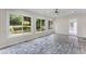 Bright sunroom featuring tiled floors, a ceiling fan, and large windows providing natural light and scenic backyard views at 2737 Fontainebleau Drive, Dunwoody, GA 30360