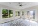 Bright sunroom featuring tiled floors, a ceiling fan, and large windows providing natural light and scenic backyard views at 2737 Fontainebleau Drive, Dunwoody, GA 30360