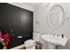 Half bathroom with toilet and sink and black textured accent wall at 2873 Overlook Ne Way, Atlanta, GA 30324