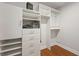 Modern closet with white shelves, drawers, cabinets and wood floor at 2873 Overlook Ne Way, Atlanta, GA 30324