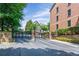 Wrought iron gate at the entrance to a beautiful community with brick pillars and greenery at 2873 Overlook Ne Way, Atlanta, GA 30324