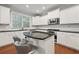 Well-lit kitchen with white cabinetry, stainless steel appliances, and hardwood floors at 2873 Overlook Ne Way, Atlanta, GA 30324