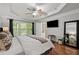 Beautiful main bedroom with tray ceilings, fan, and hardwood floors with ensuite bathroom access at 2873 Overlook Ne Way, Atlanta, GA 30324