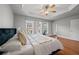 Primary bedroom with tray ceiling, ceiling fan, wood floors, and bright windows at 2873 Overlook Ne Way, Atlanta, GA 30324