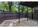 This covered patio features a wooden fence, concrete flooring and stone pavers at 2873 Overlook Ne Way, Atlanta, GA 30324
