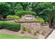 Stone monument sign for Overlook at Lenox community with lush landscaping and mature trees at 2873 Overlook Ne Way, Atlanta, GA 30324