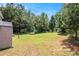 Large backyard features a wooded area, an outbuilding, and a grassy lawn at 45 Ratliff Dr, Covington, GA 30016