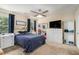 Spacious bedroom features a ceiling fan, carpeted floors, a large window, and white shelving units at 45 Ratliff Dr, Covington, GA 30016