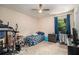 Bedroom with modest decor features a ceiling fan, window, and carpeted floors at 45 Ratliff Dr, Covington, GA 30016