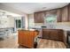 Open kitchen with dark wood cabinets, stainless steel appliances, and kitchen island at 45 Ratliff Dr, Covington, GA 30016