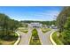 Aerial view showcasing a community with clubhouse and well-manicured landscaping in a serene environment at 604 Southland Pass, Canton, GA 30115