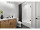 Modern bathroom featuring a shower/tub combo, black fixtures, and hexagon floor tiles at 604 Southland Pass, Canton, GA 30115