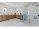 Luxurious primary bathroom with marble floors, a double vanity, and a frameless glass shower at 604 Southland Pass, Canton, GA 30115