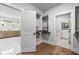 Bright bathroom featuring a walk-in closet, wooden floors, and vanity with a large mirror above at 604 Southland Pass, Canton, GA 30115