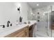 Close-up of the primary bath includes custom vanity, wall sconces, mirror and a large walk-in shower at 604 Southland Pass, Canton, GA 30115