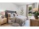 Comfortable bedroom features a plush bed, decorative lamps, and a window with a view at 604 Southland Pass, Canton, GA 30115