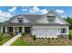 Charming new construction home with a welcoming front porch and manicured lawn at 604 Southland Pass, Canton, GA 30115